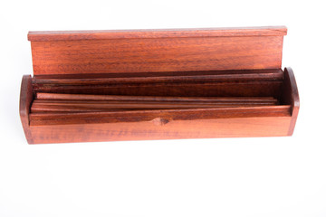 Chopsticks in the wooden box on white background