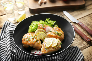 Plate of delicious tequila lime chicken on wooden background