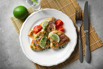 Plate of delicious tequila lime chicken on light background