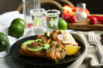 Plate of delicious tequila lime chicken on table