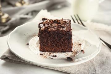 Plate with delicious cocoa brownie on table