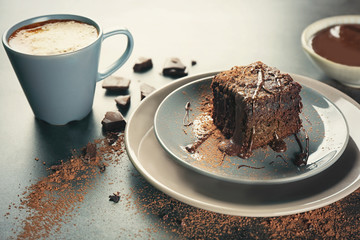Plates with delicious cocoa brownie on table