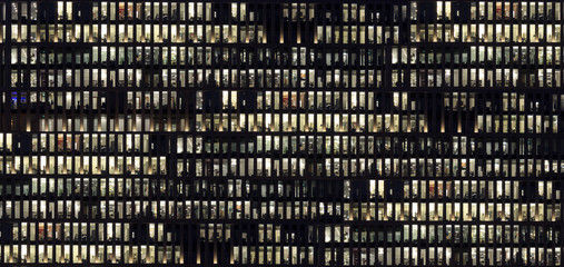modern office building facade, people working at night