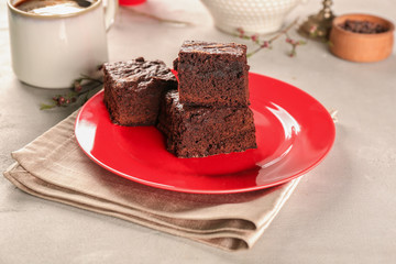 Plate with delicious cocoa brownies on table