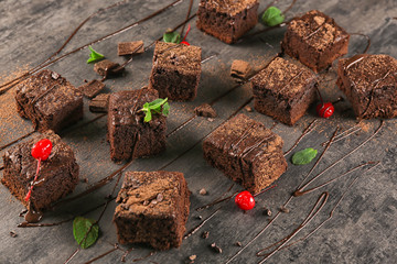 Delicious cocoa brownies on table