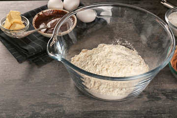 Bowl with flour for preparing  cocoa brownies on table