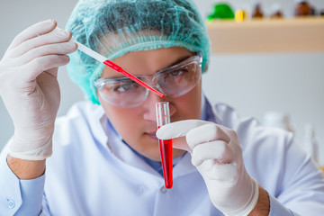 Young doctor working on blood test in lab hospital