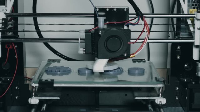 3d printer printing plastic parts gears and pulleys