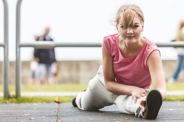 Active woman stretching warming up. Exercise.