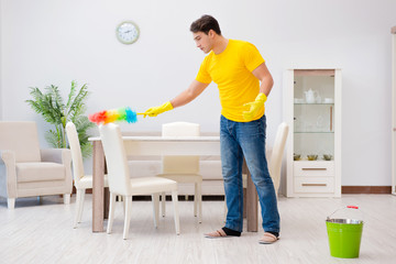 Man cleaning the house helping his wife