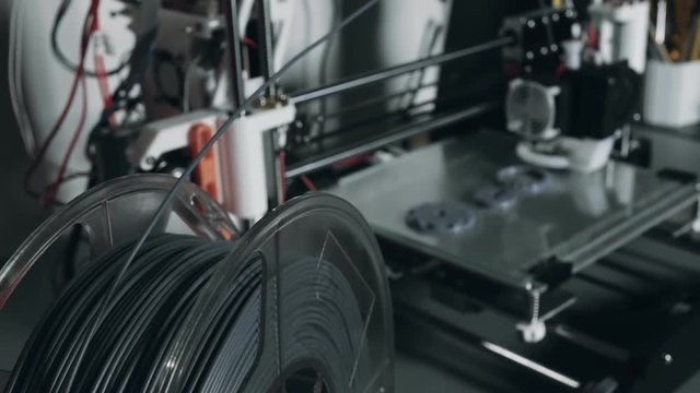 3d printer printing plastic parts gears and pulleys using pla filament