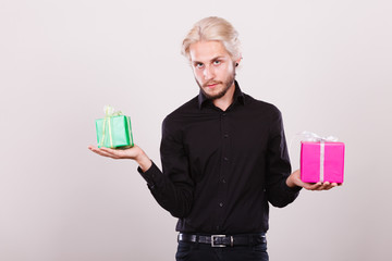 man holding two gift boxes in hands