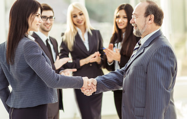handshake of business partners after signing the contract