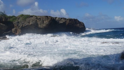 Foams of white waves roll in from the ocean to the shore