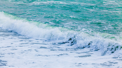 Naklejka na ściany i meble Blue sea with waves. Waves in ocean Splashing Waves