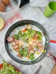 pan-fried egg with toppings in Thai style. Kitchenware background.