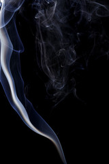 Abstract art. Color white blue smoke from the aromatic sticks on a black background. Background for Halloween. Texture fog. Design element. The concept of aromatherapy.