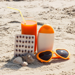 Medical pills, carrot juice and accessories for sunbathing at beach, vitamin A and beautiful, lasting tan