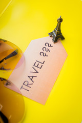 question: where to go on a trip? Time to travel?  travel banner on yellow background. Traveling mood. travel and vacations concept. small symbol of france. statuette, figurine of eiffel tower.