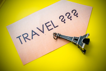 question: where to go on a trip? Time to trave l?  travel banner on yellow background. Traveling mood. travel and vacations concept. small symbol of france. statuette, figurine of eifel tower.