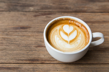 cup of coffee on wood table blackground