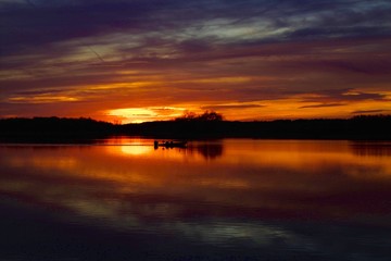 Fototapeta premium Boat On river sunset