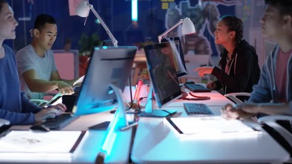  Young Asian video game developers working together on a project