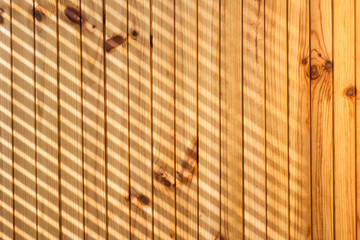 Light yellow wood pattern with diagonal light rays lines. Wood background for mock-ups.