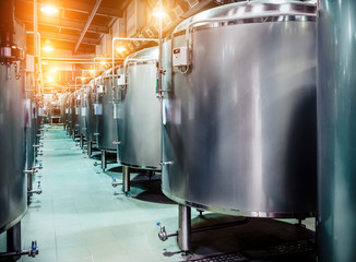 Rows of steel tanks for beer fermentation and maturation.