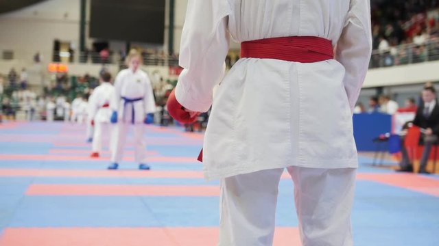 Sports kids - girl sportsmen on karate - looking to competitor