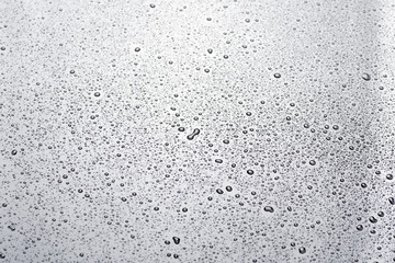 closeup to water drops on glass with lighting background