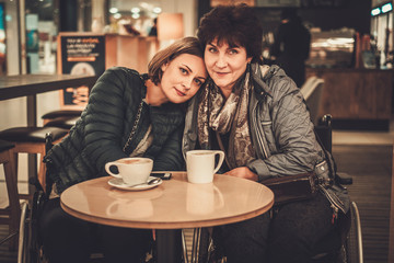 Two physically challenged women in a cafe