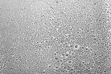 closeup to water drops on glass with lighting background