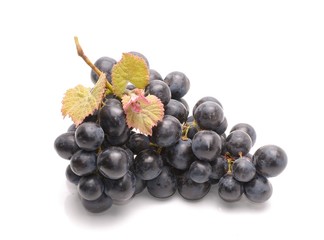   Purple grape with green leaf isolated on white background