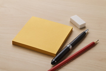 Note with pen, pencil and eraser