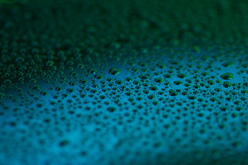 closeup to water drops on glass with lighting background