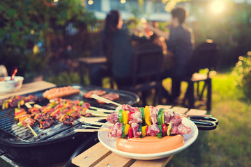 Dinner party, barbecue and roast pork at night - obrazy, fototapety, plakaty