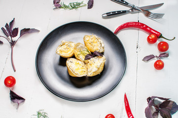 Italian pasta Conchiglioni Rigati stuffed with cheese on white wood table