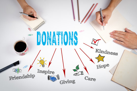Donations Concept. The meeting at the white office table.