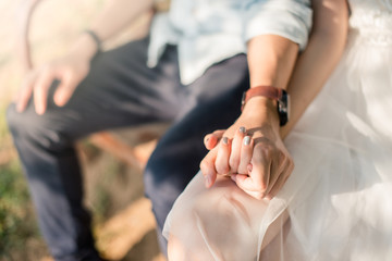 Obraz na płótnie Canvas Closeup of woman and man holding hands together