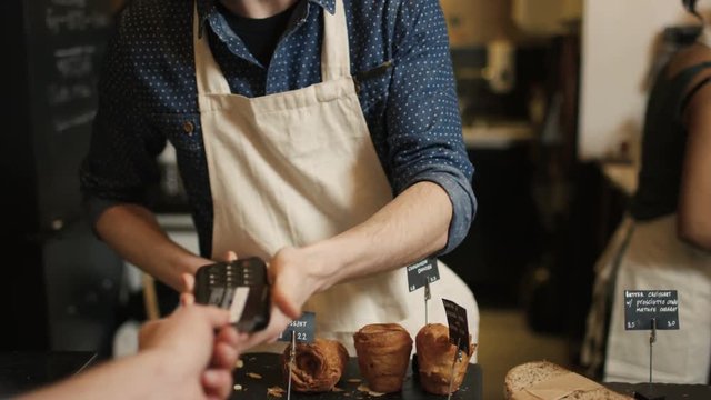  Cafe worker serving customer & taking payment, seen from customer's pov