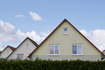 Three houses with pitched roofs