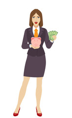 Businesswoman holding a piggy bank and showing cash money