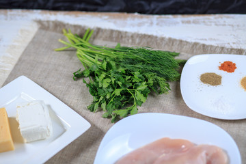 Fresh greens fennel parsley onions on a gray background
