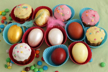 Easter eggs and colorful sweet cupcakes
