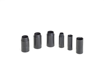 A set of cylindrical steel punches.