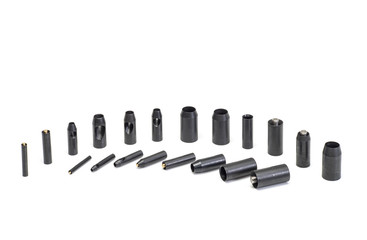 A set of cylindrical steel punches.
