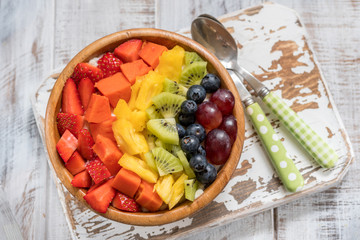 Breakfast oatmeal for kids topped with rainbow fruits