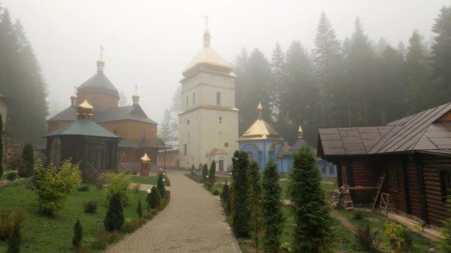 Walk by Alley on Manyava Skete Courtyard Orthodox Male Monastery Among Carpathian Mountains Coniferous Forest Behind Wall Foggy Day Ancient Architecture