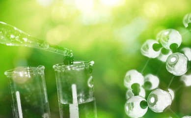 test tube and drop of water with science chemical structure on green